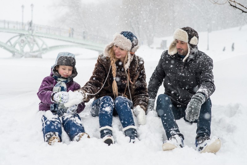 family playing in snow